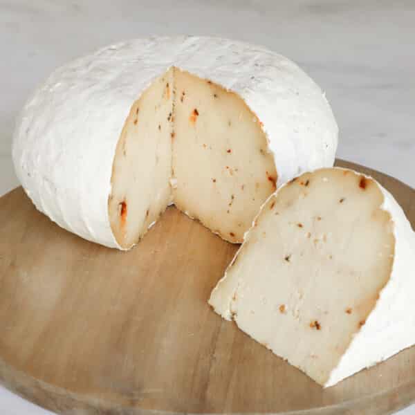 Whole Sharpham Rustic with Smoked chilli cheese sliced to show wedge