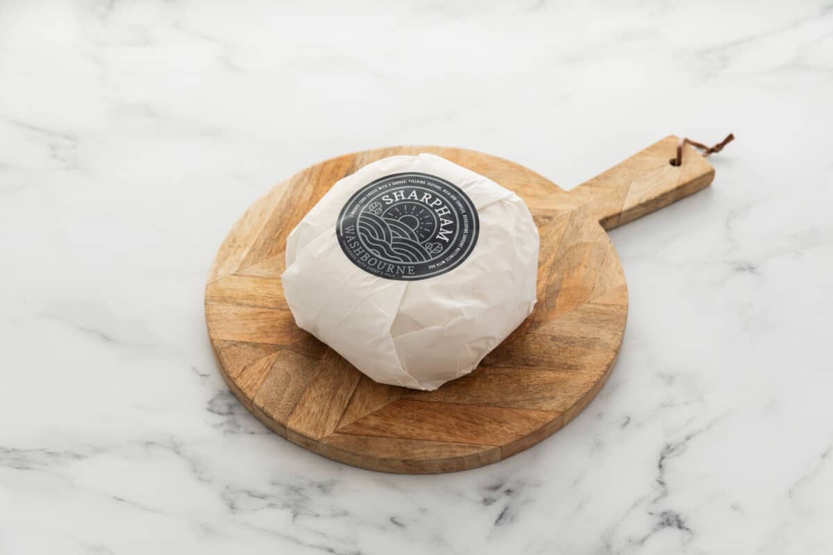 Sharpham Washbourne Ewes milk cheese wrapped with branded blue label